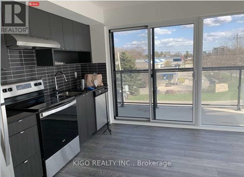 A kitchen with a large window overlooking a grassy area.