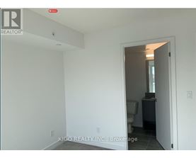 A white room with a doorway leading to another room.