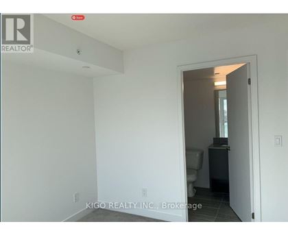 A white room with a doorway leading to another room.