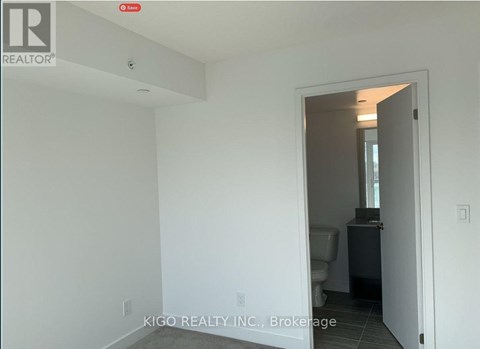 A white room with a doorway leading to another room.