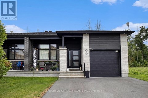 A house with a garage and a sign that says Century 21 Synergy Realty Inc. Brokerage.