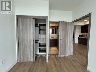 A realtor's office showcases a modern kitchen and living room.