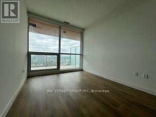 A room with a sliding glass door leading to a balcony.