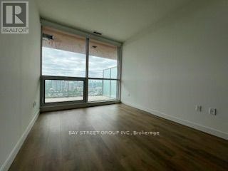 A room with a sliding glass door leading to a balcony.