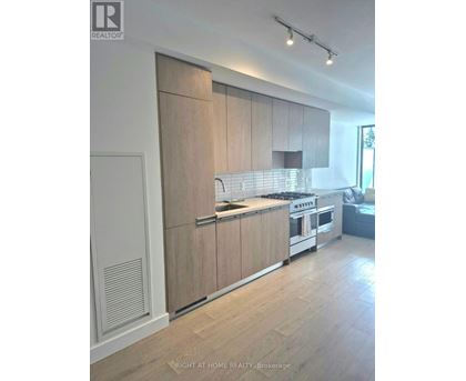 A modern kitchen with wooden cabinets and stainless steel appliances.