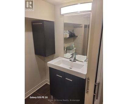 A bathroom with a sink and a mirror.