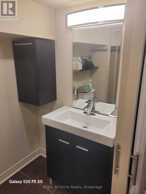 A bathroom with a sink and a mirror.