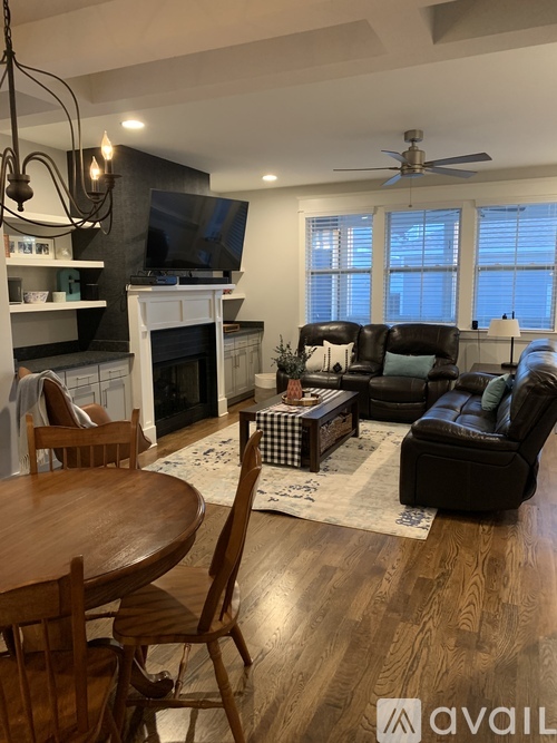 A living room with a fireplace and a television.