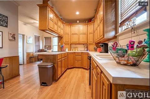 A kitchen with wooden cabinets and a white countertop.
