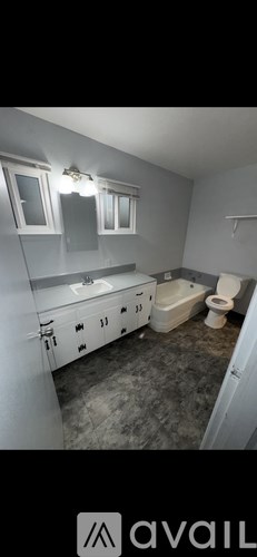 A bathroom with a toilet, sink, and bathtub.