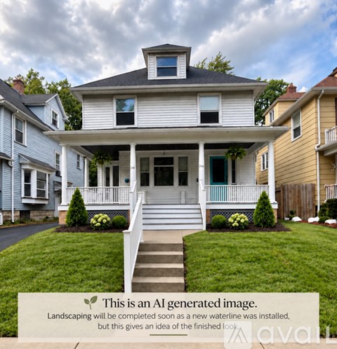 A two-story house with a front porch and a waterline.