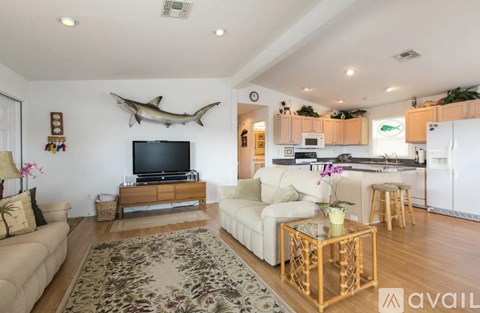 A living room with a white couch and a wooden coffee table.