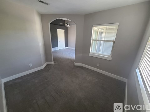 A spacious room with a fan and a window.