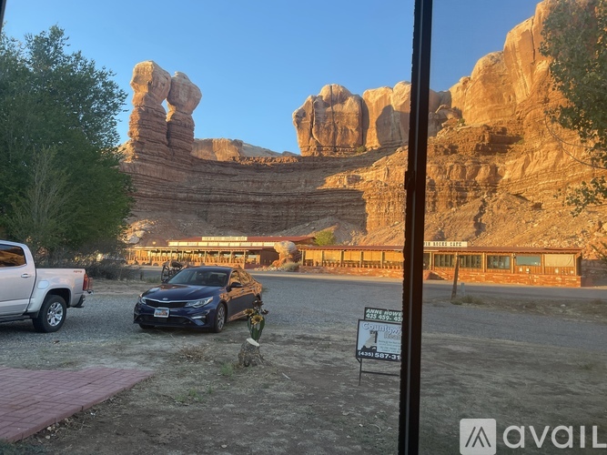 A car is parked in front of a sign that says "AVAILABLE".