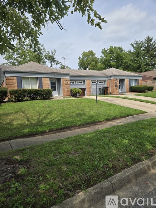 A house with a green lawn in front of it.