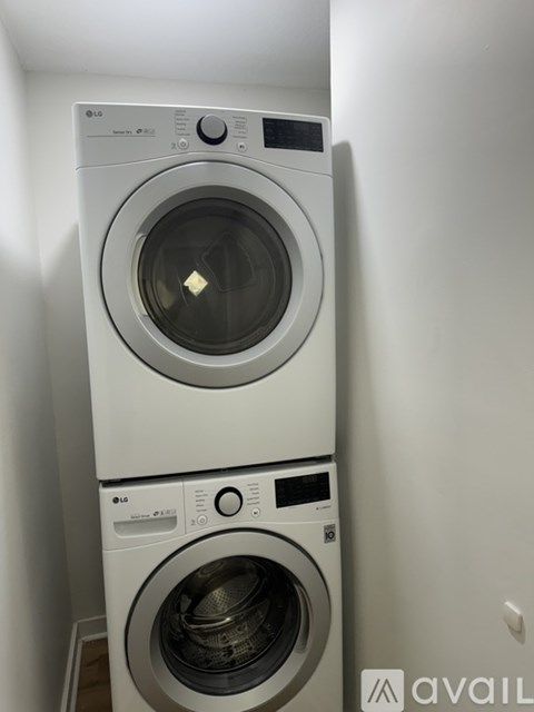 A stack of two LG front loading washing machines.