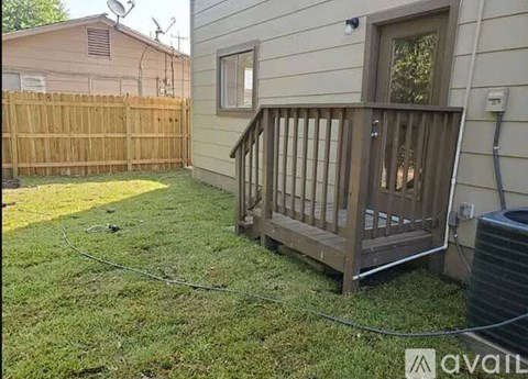 A wooden deck is attached to a house.