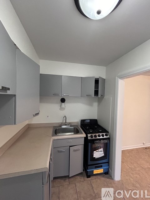 A kitchen with a stove and sink.