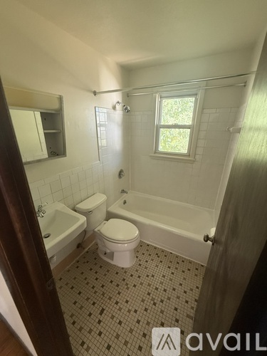 A bathroom with a toilet, sink, and bathtub.