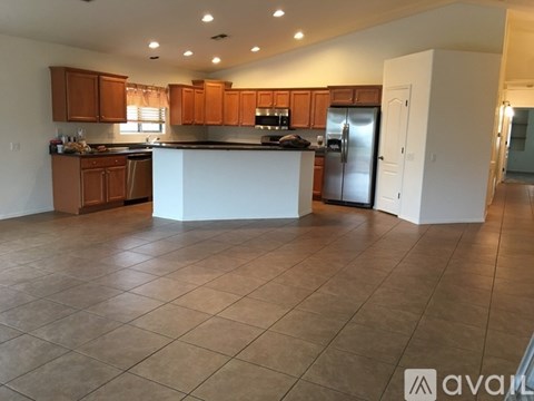A kitchen with brown cabinets and a white island.