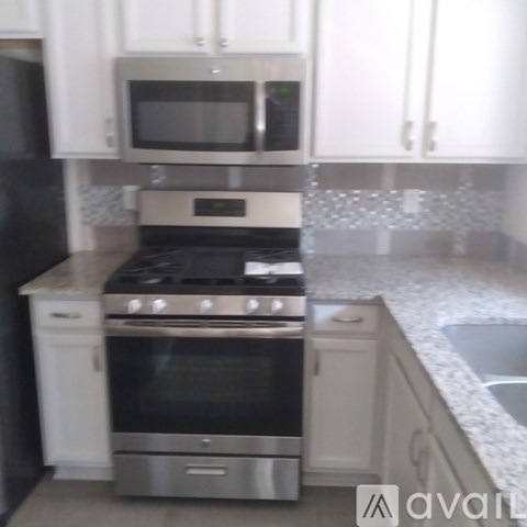 A kitchen with a stove top oven and microwave above it.