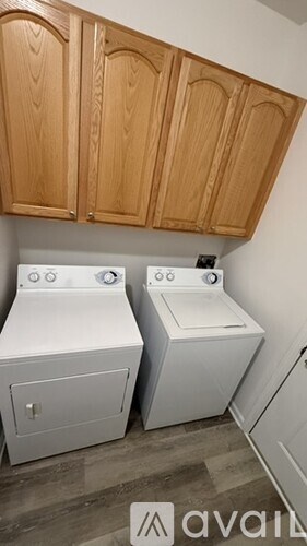 A washing machine and dryer in a small laundry room.