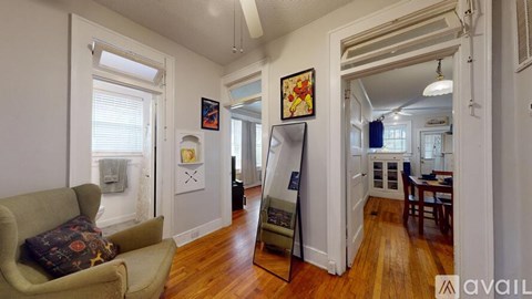 A living room with a couch and a painting on the wall.