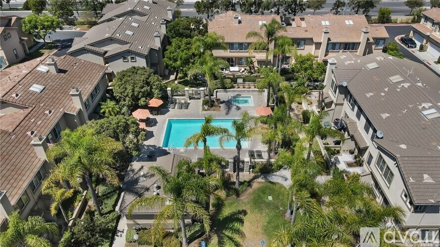 A bird's eye view of a residential area with a swimming pool.