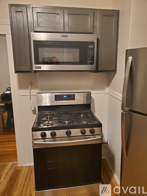 A modern kitchen with a stainless steel oven and microwave above the stove.