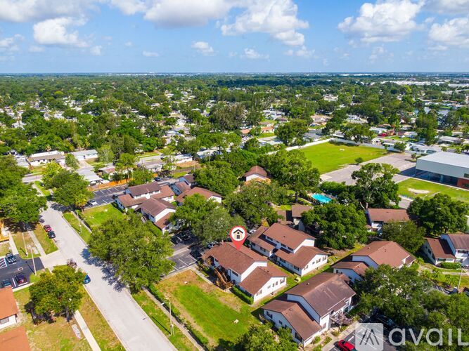 A bird's eye view of a residential area with houses and trees.