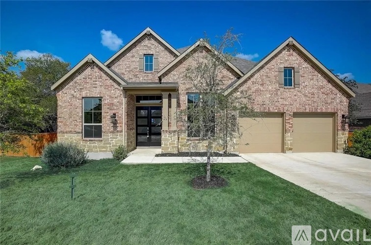 A house with a brick facade and a large front yard.