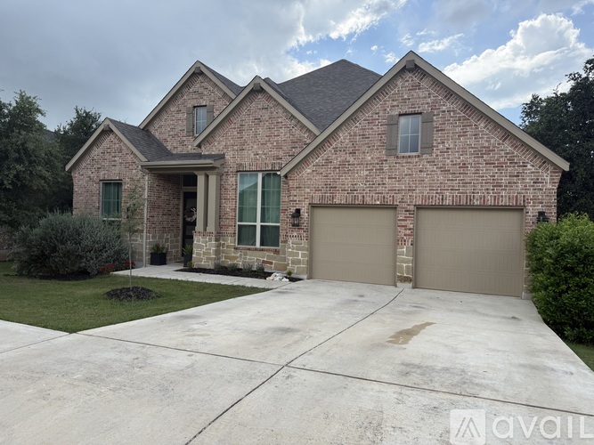 A house with a brick facade and a large driveway.