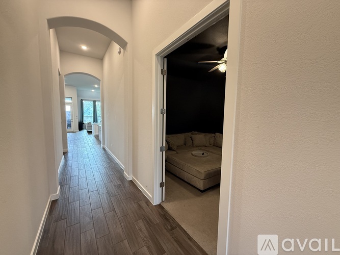 A long hallway with a bedroom at the end.
