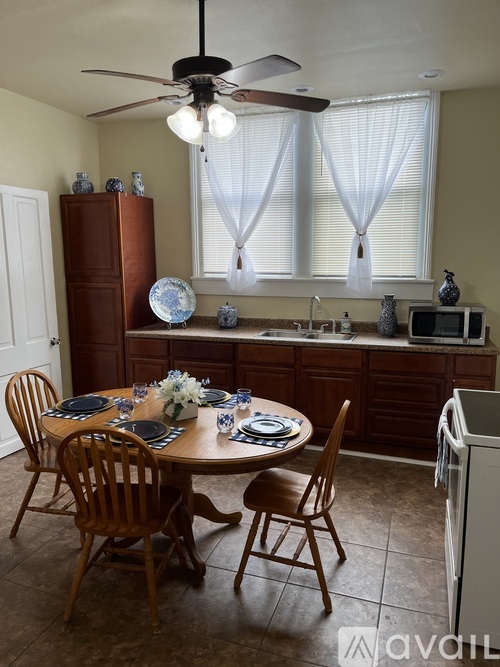 A kitchen with a table set for a meal.