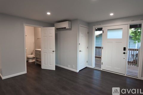 A room with a toilet and a bed in it.