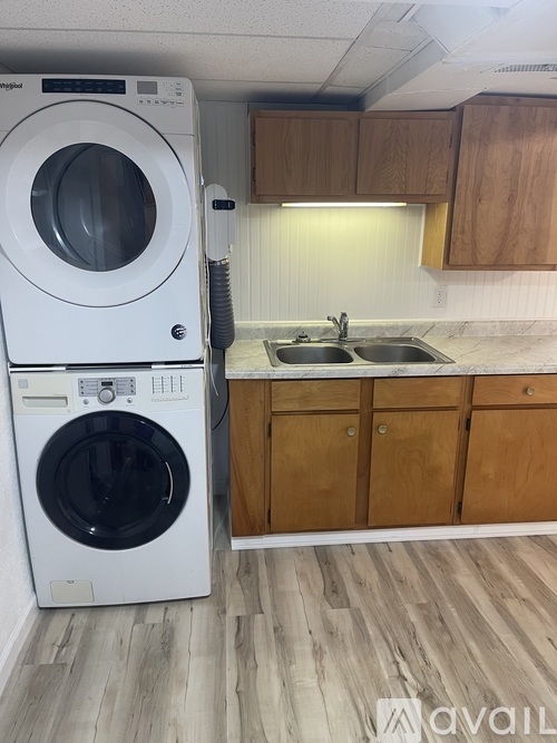 A white washer and dryer in a small laundry room.