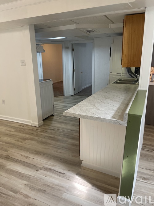 A kitchen with a counter top and cabinets.