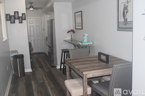 A dining area with a wooden table and chairs.