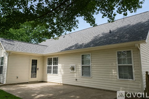 A house with a white exterior and a grey roof is available for rent.