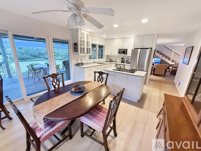 A modern kitchen with a dining table and chairs.