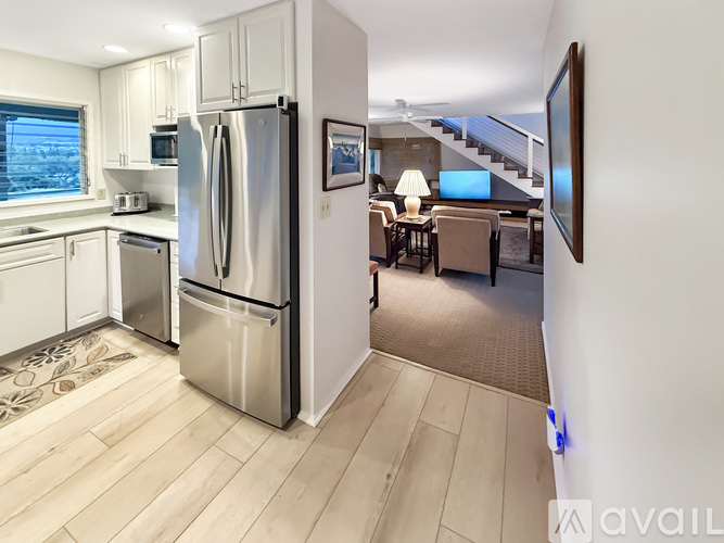 A kitchen with a refrigerator, stove, and oven.