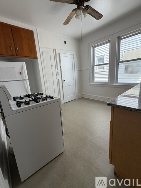 A kitchen with a white fridge and a white stove.