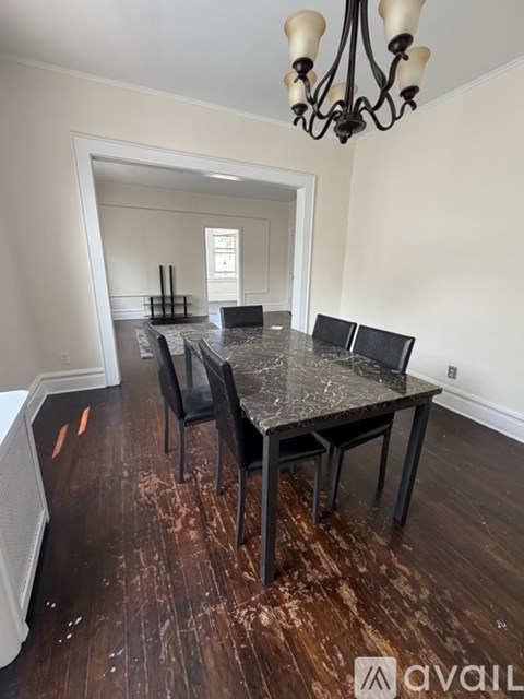 A dining room with a marble table and chairs.