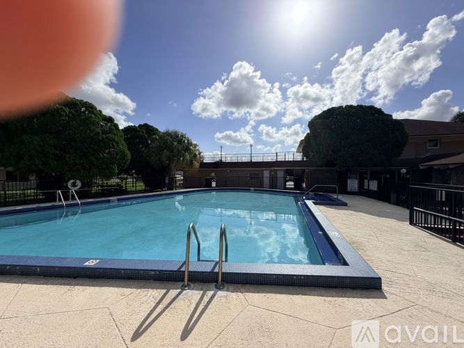 A sunny day at the outdoor pool with a clear blue sky.