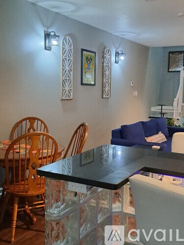 A dining area with a table and chairs.