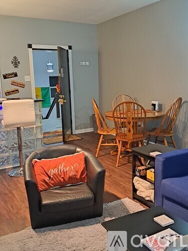 A living room with a black leather chair and a blue chair.