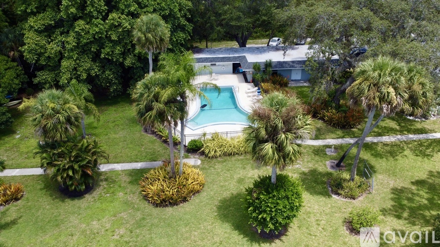 A backyard with a pool and trees.