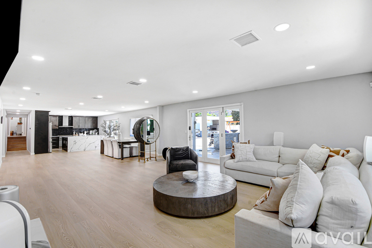 A modern living room with a white couch and a wooden coffee table.
