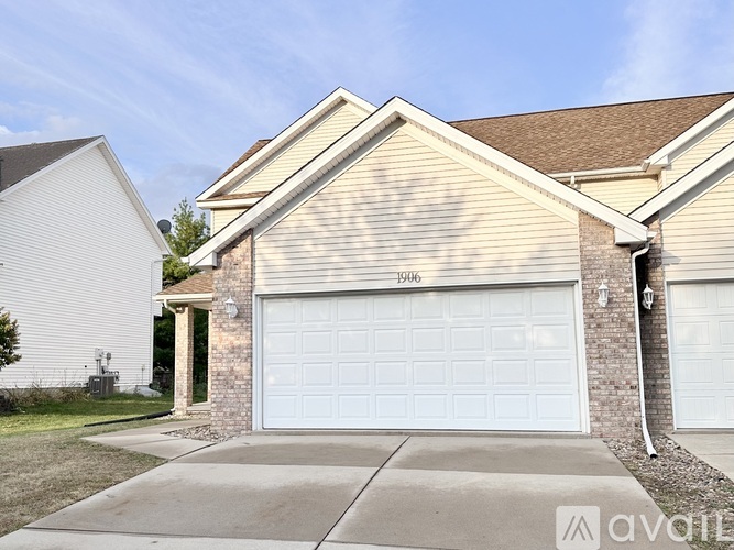 A two-story house with a garage door that says "1000" on it.