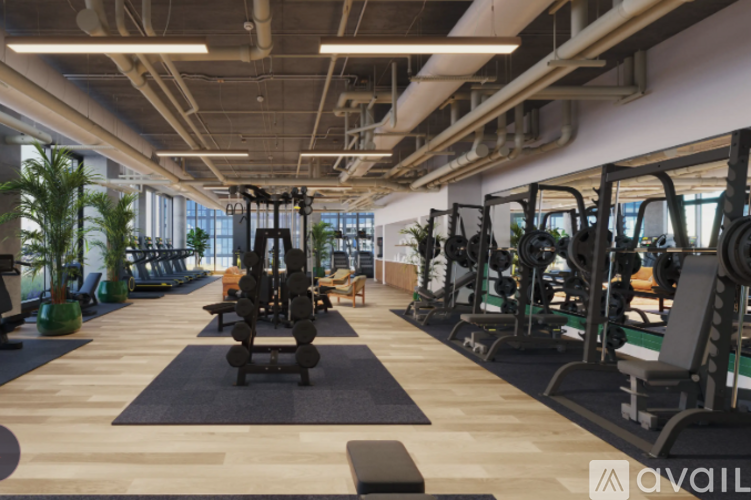 A gym with a variety of equipment including treadmills, weights, and exercise machines.
